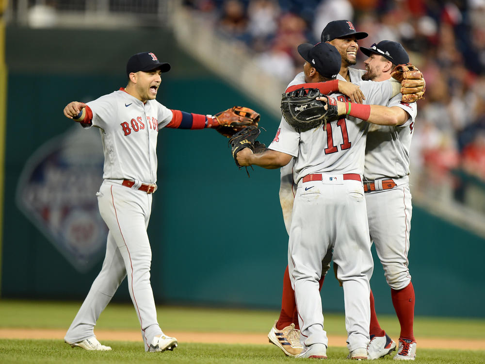 Players for the Boston Red Sox celebrate after a 7-5 victory against the Washington Nationals on Sunday. The Red Sox will play the New York Yankees in the American League wild card game on Tuesday.