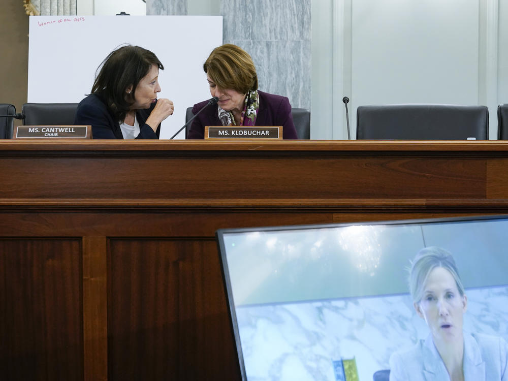 Sen. Maria Cantwell, D-Wash., (top left) speaks with Sen. Amy Klobuchar, D-Minn., as Antigone Davis, Facebook's global head of safety, testifies virtually before the Senate Commerce, Science and Transportation Subcommittee on Consumer Protection, Product Safety and Data Security during a hearing on children's online safety and mental health on Thursday in Washington.