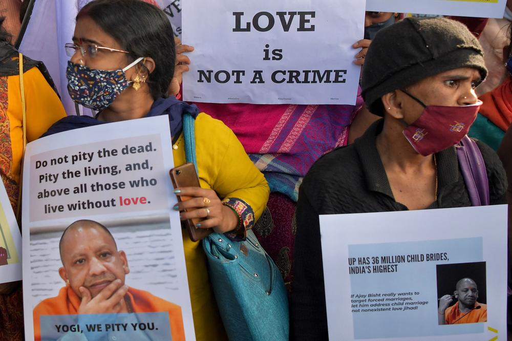 Human rights activists hold placards during a demonstration condemning proposed laws against 