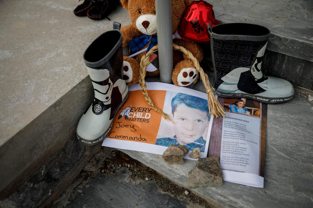A photo of Joey Commanda, a boy who died while running away from the Mohawk Institute, sits at a makeshift memorial on the steps of the former boarding school in Brantford, Ontario.
