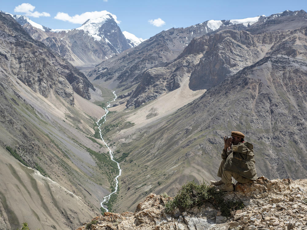 A Wakhi man looks out at the mountains in the Wakhan corridor of Afghanistan. Uyghurs leaving China have trekked through the region. Now many Uyghurs in Afghanistan fear the Taliban could deport them to China.