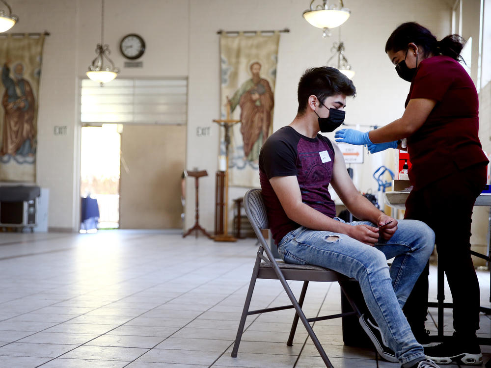 A person receives the Pfizer COVID-19 vaccine at a clinic at St. Patrick's Catholic Church in Los Angeles in April.