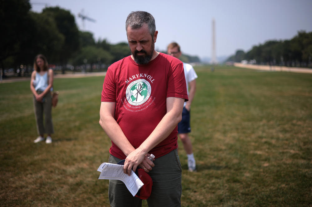 Participants bow their heads in prayer during a COVID-19 prayer vigil on the National Mall honoring and mourning those who have died due to the coronavirus pandemic in Washington, D.C., in July.