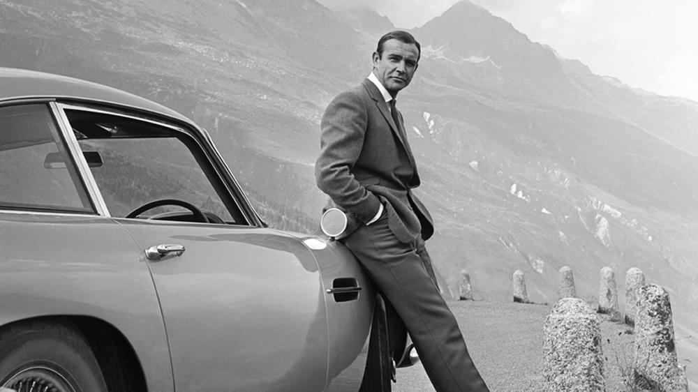 Sean Connery and Bond's famed Aston Martin DB5, during the filming of <em>Goldfinger.</em>