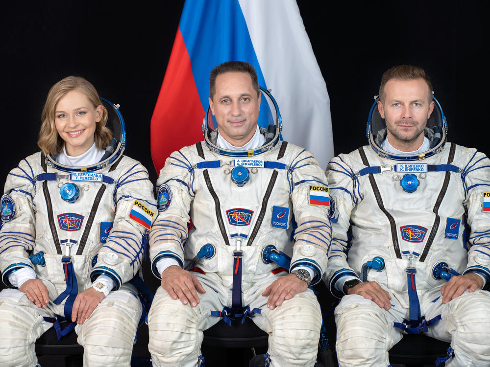 Cosmonaut Anton Shkaplerov (center), along with film director Klim Shipenko (right) and actor Yulia Peresild (left) pose for a photo ahead of the launch of the Soyuz MS-19 spacecraft to the International Space Station from Kazakhstan's Baikonur Cosmodrome.