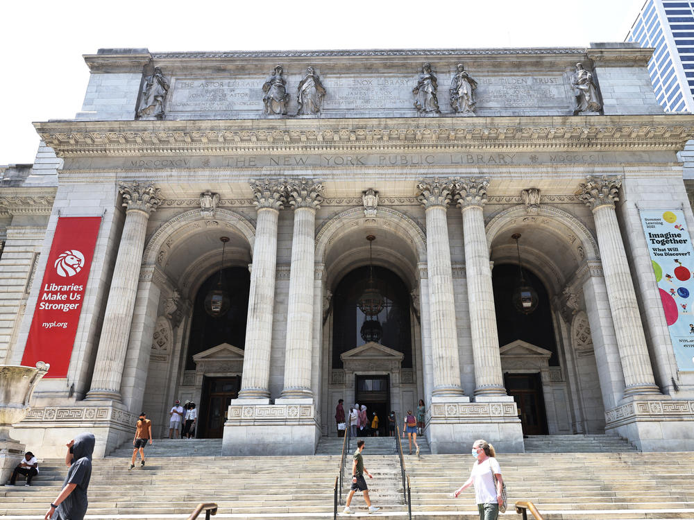 People walk along the stairs of the New York Public Library on July 06, 2021 in Midtown Manhattan in New York City.