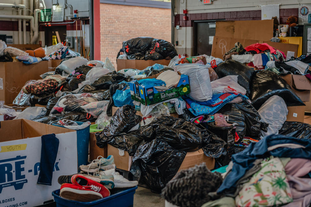 Volunteers have sorted the bags of clothing for the refugees so they can find what they need. Many arrived with only the clothes on their back.
