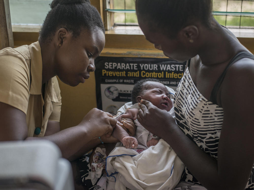A nurse administers the world's first malaria vaccine during a 2019 pilot program in Ghana. The World Health Organization has now recommended the vaccine for use in countries with moderate to high levels of malaria transmission.