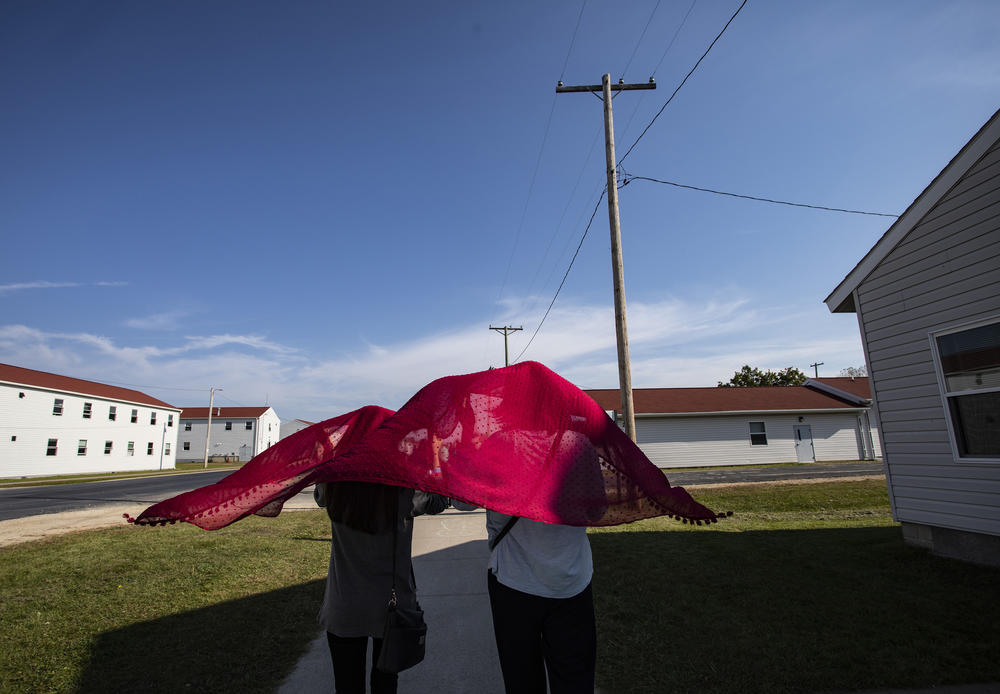 Young Afghan refugees walk through the Village at the Ft. McCoy U.S. Army base on September 30, 2021 in Ft. McCoy, Wisconsin. The Village is the community housing for the Afghans, comprised of eight neighborhoods where the evacuees live, eat, and receive services and support.