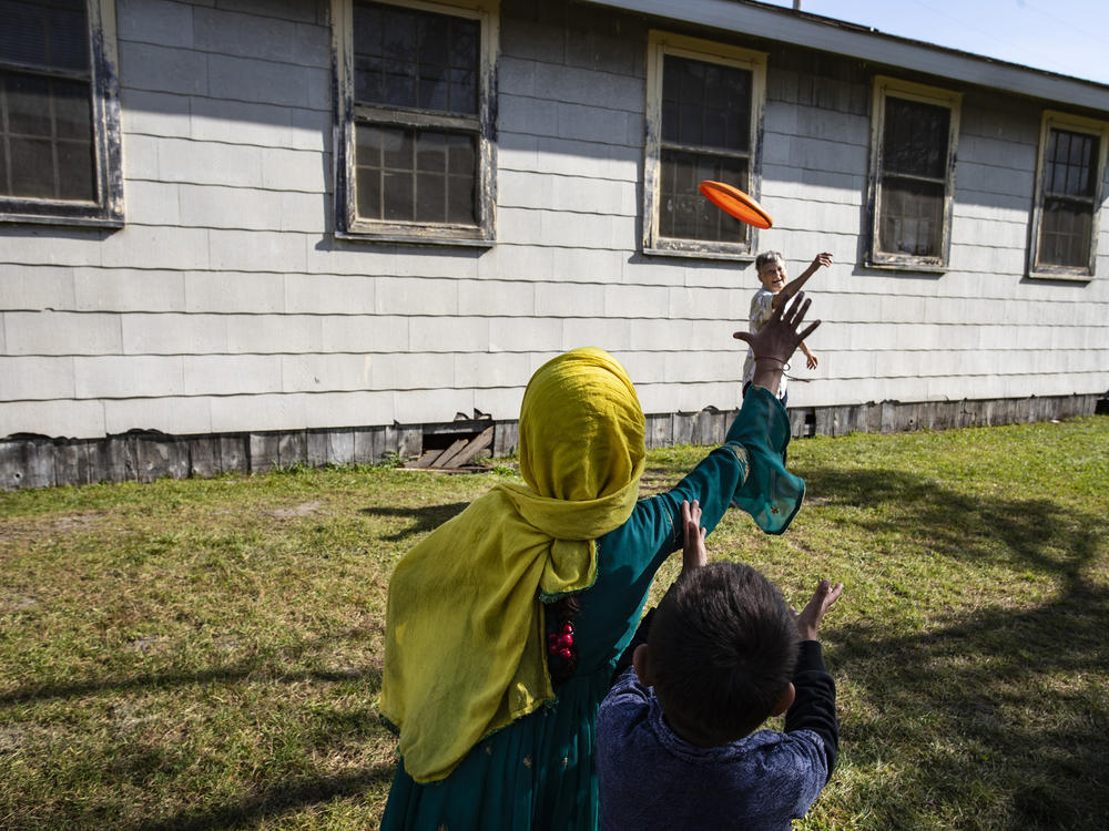Volunteer Sandra Hoeser plays frisbee with Afghan refugees at Fort McCoy on Sept. 30. There are nearly 13,000 Afghan refugees being cared for at the base under Operation Allies Welcome.