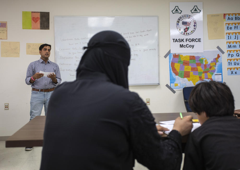 The refugees attend a class at the base.