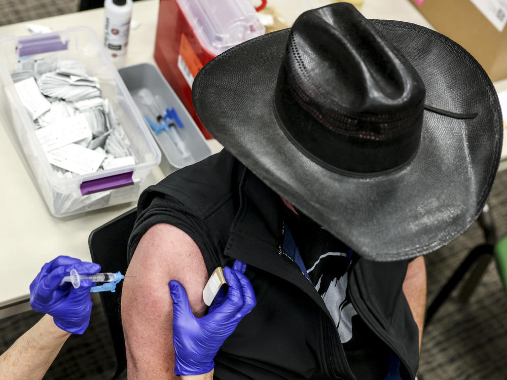 Colorado's UCHealth hospital system is requiring any prospective organ transplant recipients to get the COVID-19 vaccine. Here, a man receives a COVID-19 vaccine in Thornton, Colo., earlier this year.