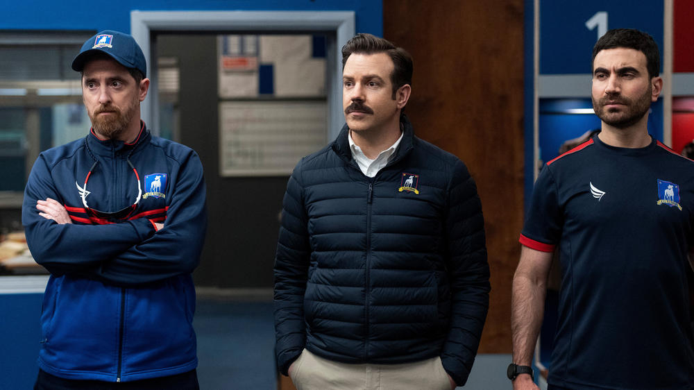 Brendan Hunt, Jason Sudeikis and Brett Goldstein as three coaches in a tense moment: Beard, Ted and Roy.