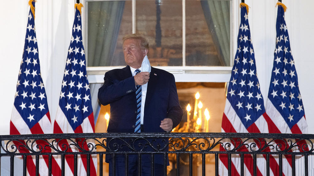 Trump removes his mask upon his return to the White House from Walter Reed National Military Medical Center on Oct. 5, 2020. Trump spent three days hospitalized for COVID-19.