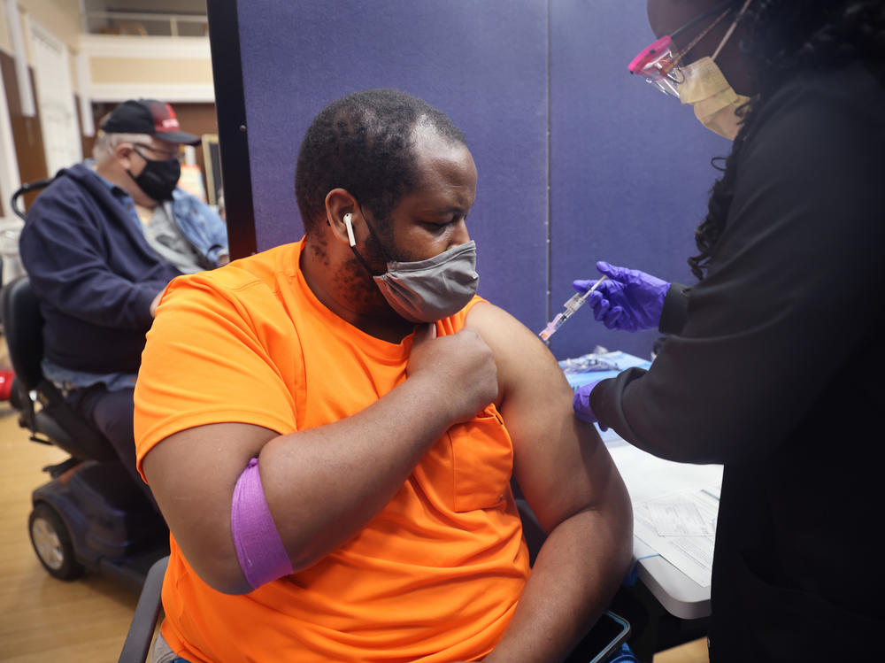 Gloria Clemons gives a COVID-19 vaccine to Navy veteran Perry Johnson at the Edward Hines, Jr. VA Hospital in Hines, Ill., in September.