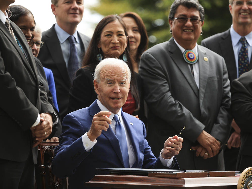 President Biden finishes signing one of three executive orders to expand the areas of three national monuments during an event at the White House on Friday.