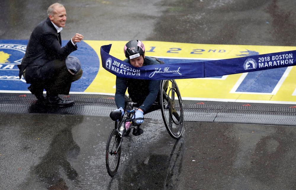 Tatyana McFadden, of the United States, crosses the finish line to win the women's wheelchair division of the 122nd Boston Marathon on Monday, April 16, 2018, in Boston.