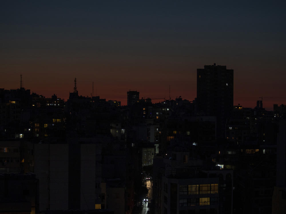 In this photo, Lebanon's capital city of Beirut remains in darkness during a power outage in March. Lebanon has had electricity cuts for decades but in recent weeks the small nation suffered severe power cuts over lack of fuel.