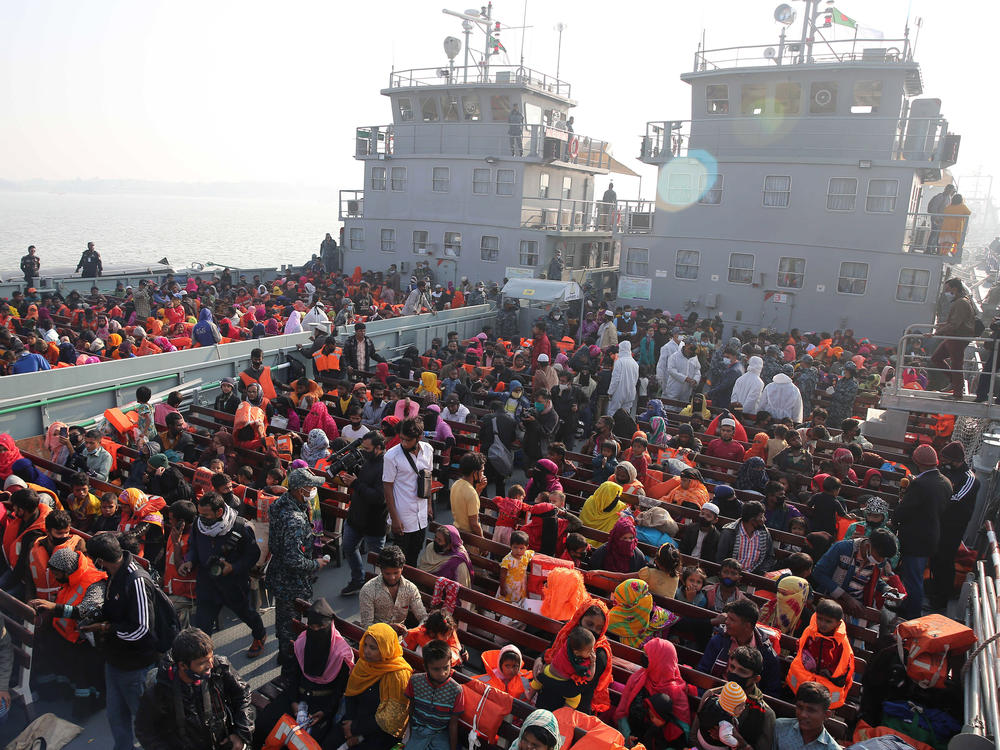 In this Dec. 29, 2020, file photo, Rohingya refugees wait on naval ships to be transported to an isolated island in the Bay of Bengal, in Chittagong, Bangladesh.