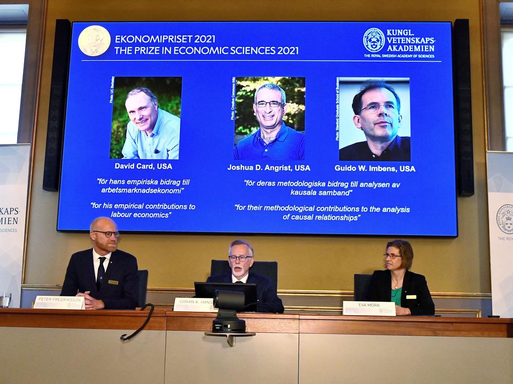 Goran K. Hansson (C), Permanent Secretary of the Royal Swedish Academy of Sciences, and Nobel Economics Prize committee members Peter Fredriksson (L) and Eva Mork (R) give a press conference to announce the winners of the 2021 Sveriges Riksbank Prize in Economic Sciences in Memory of Alfred Nobel.