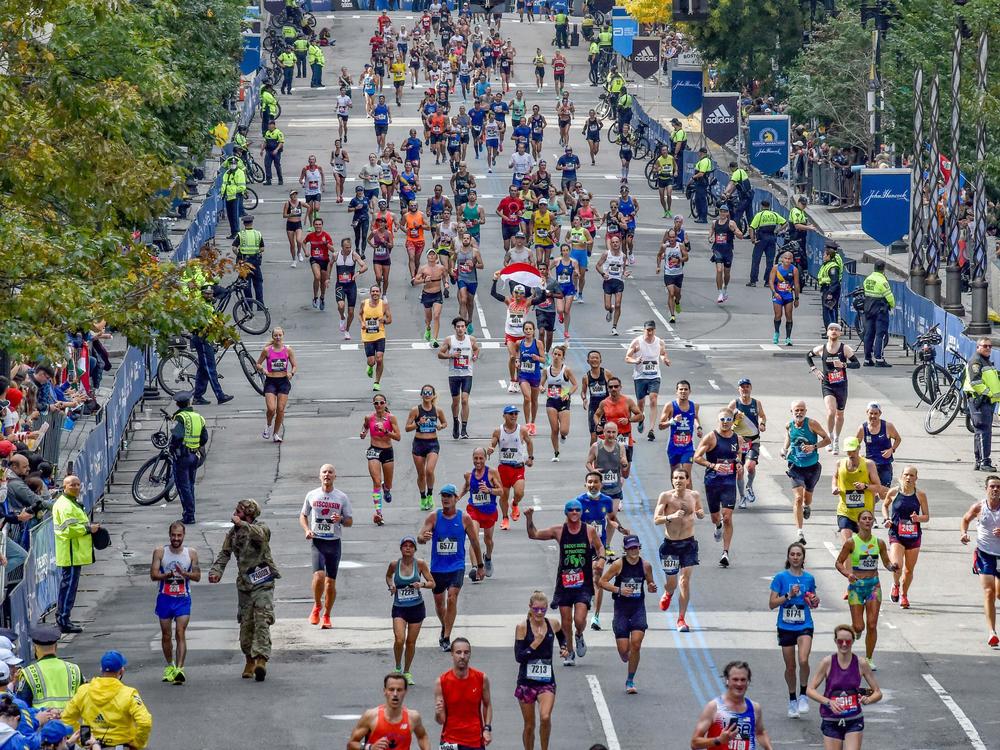 Runners make their way to the finish line down Boylston Street during the 125th Boston Marathon in Boston, Massachusetts on Monday. It's the first time the event has been held in the fall in more than a century.