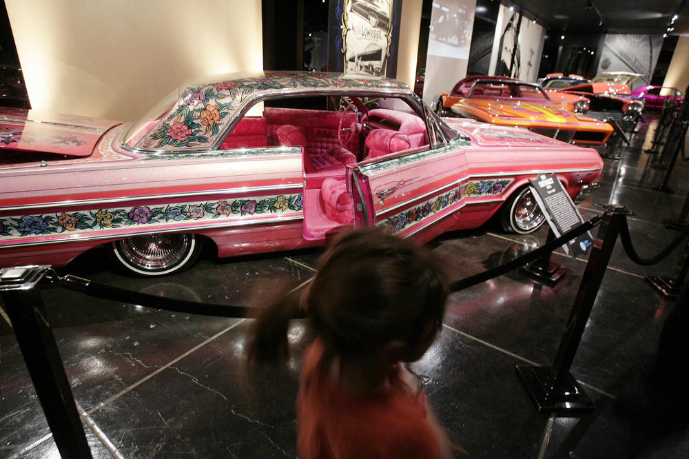 Visitors to the Peterson Automobile Museum in Los Angeles examine the Gypsy Rose, a 1964 Chevrolet Impala and one of the most famous lowriders in history, in this 2008 file photo.