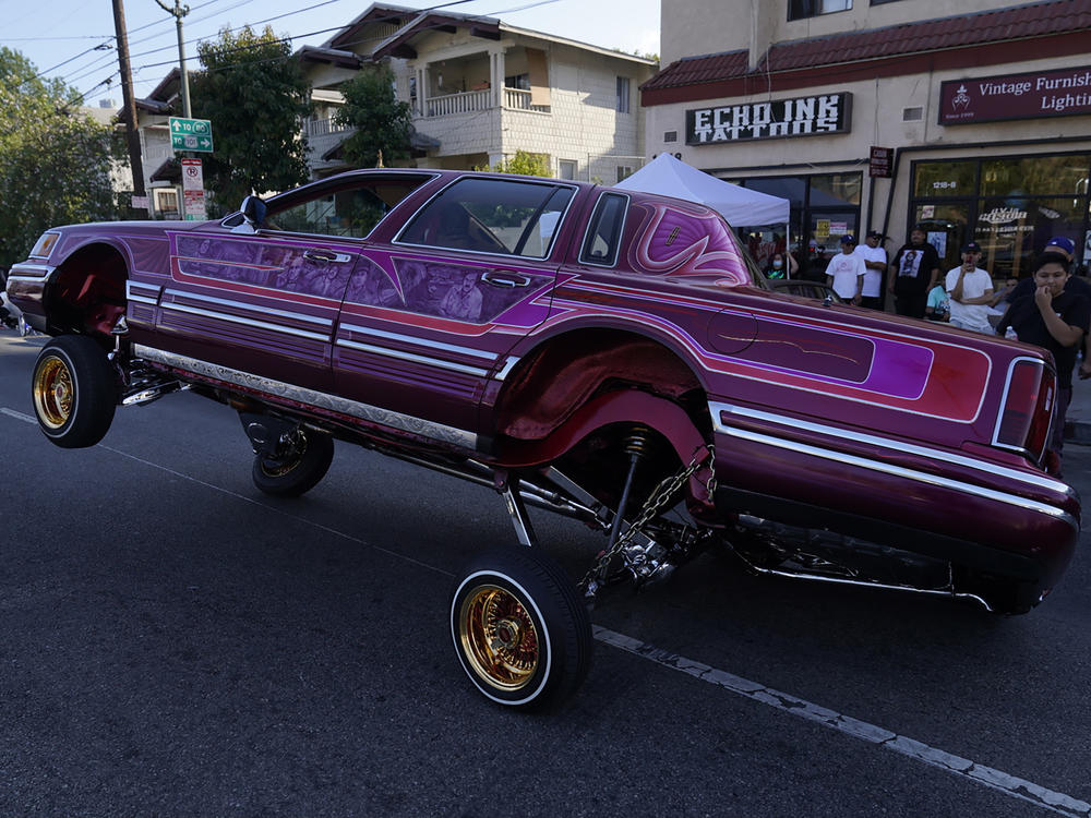 A Lowrider rides on three-wheels on Sunset Blvd., in the Echo Park neighborhood of Los Angeles in July.