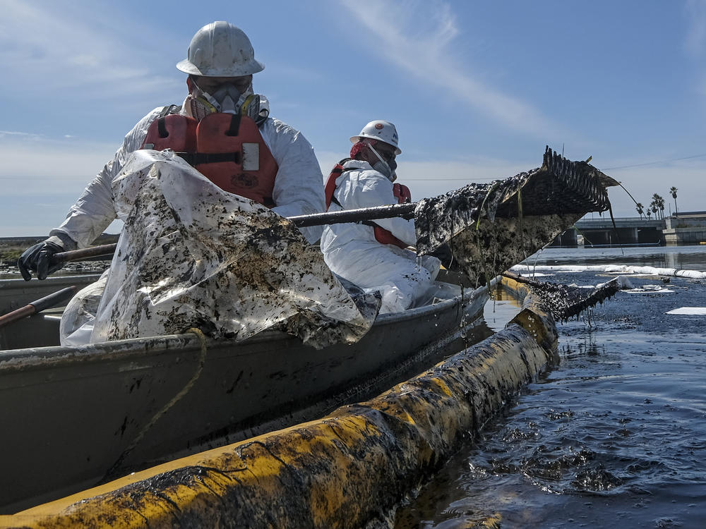 Cleanup contractors deploy skimmers and floating barriers known as booms to try to stop further crude oil incursion into Talbert Marsh in Huntington Beach, Calif., on Oct. 3 after an oil spill off the Southern California coast.