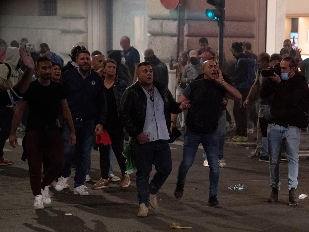 Giuliano Castellino (center), a leader of the extreme-right political party Forza Nuova, shouts during clashes Saturday following a protest against the mandatory 