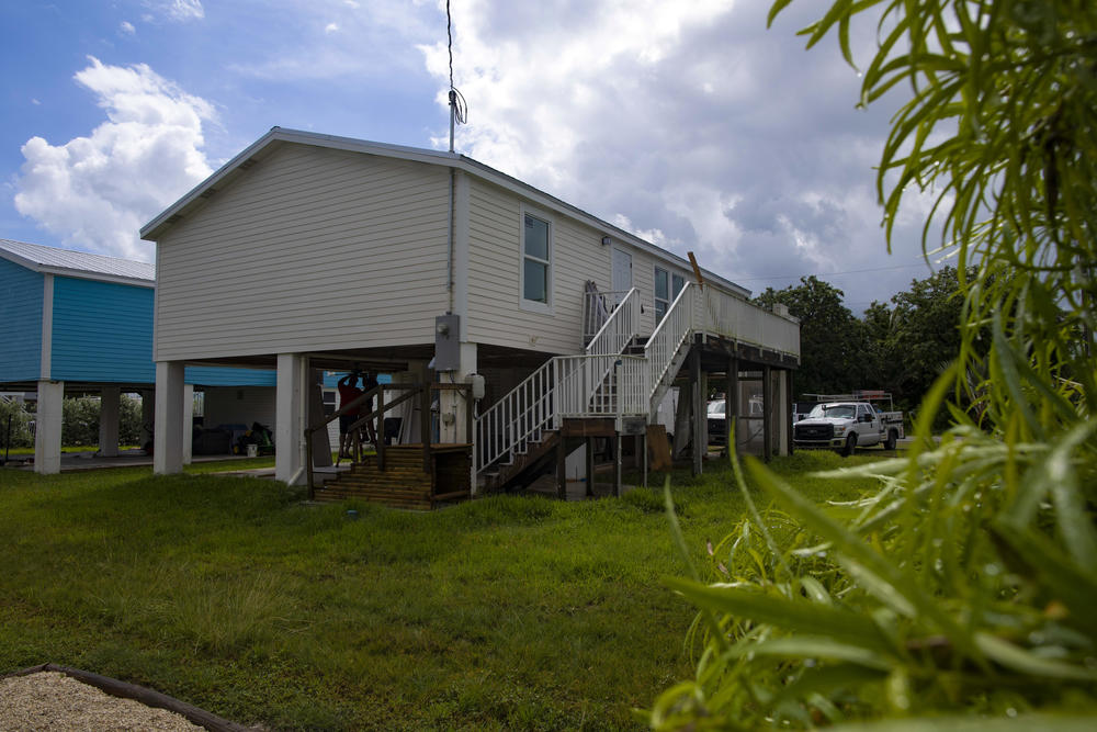 Amy Tripp's home sits on a platform to avoid flooding damage, but the flood insurance rate for the home will still go up.