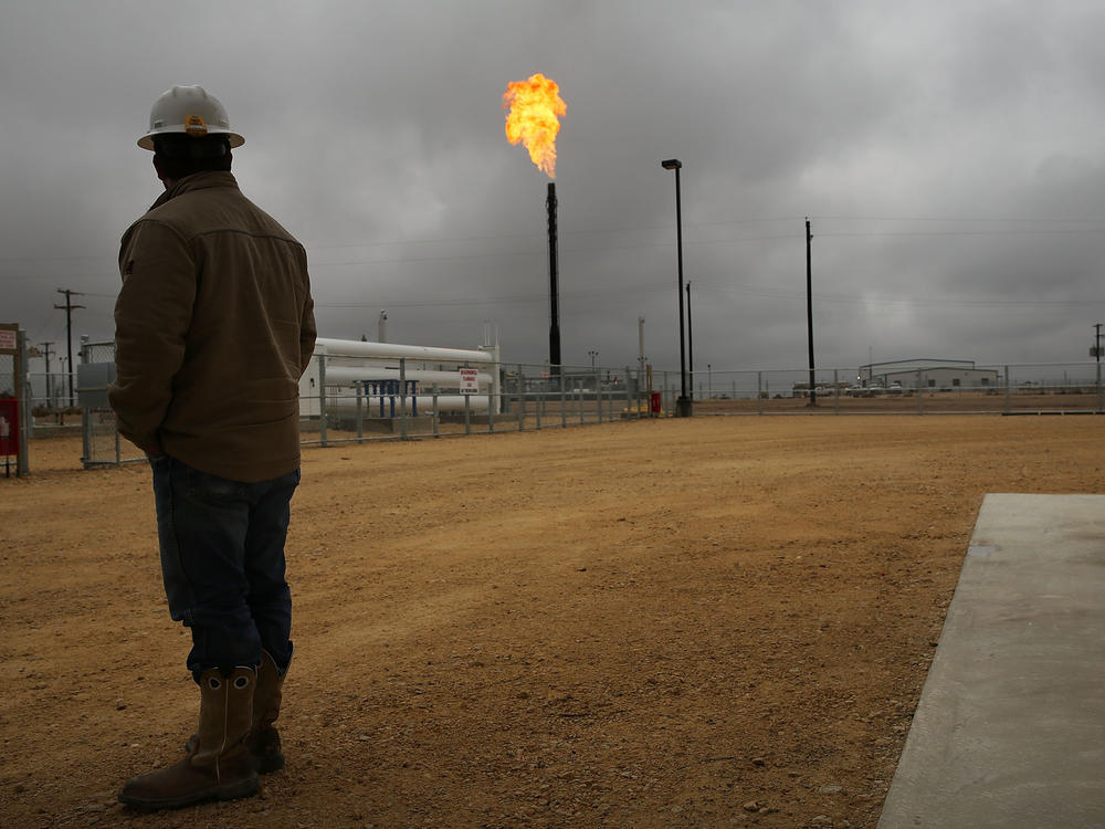 Flared natural gas is burned off at Apache Corporation's operations at the Deadwood natural gas plant in Garden City, Texas, on Feb. 5, 2015.