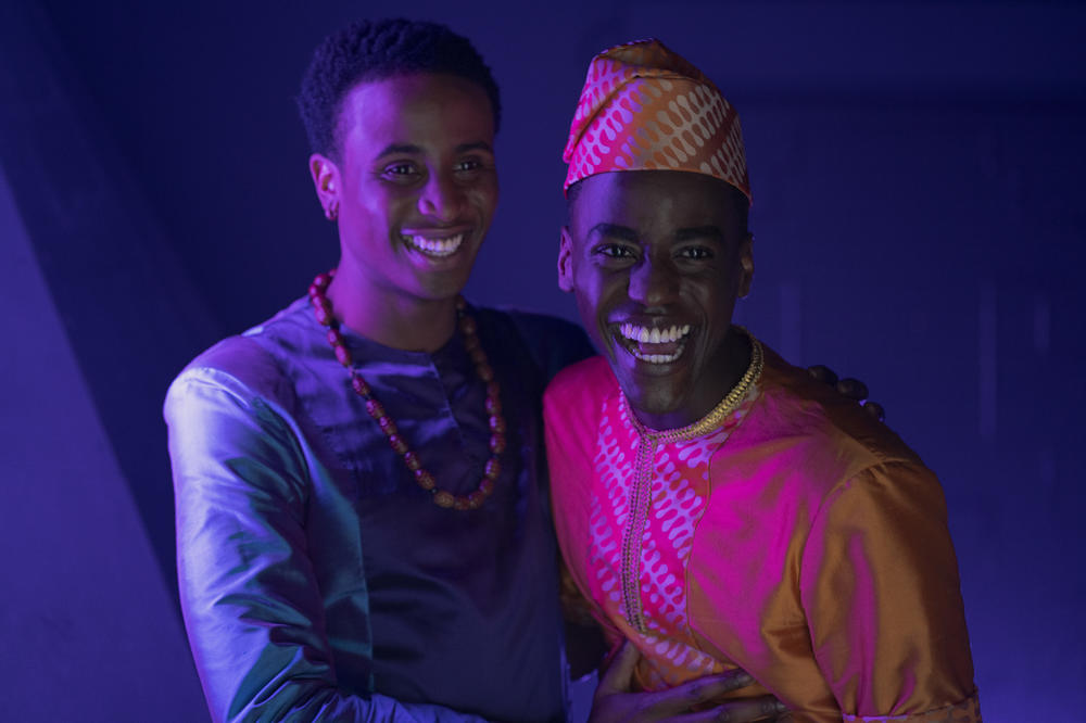 Eric, right, wears traditional garb for a family wedding in Nigeria.