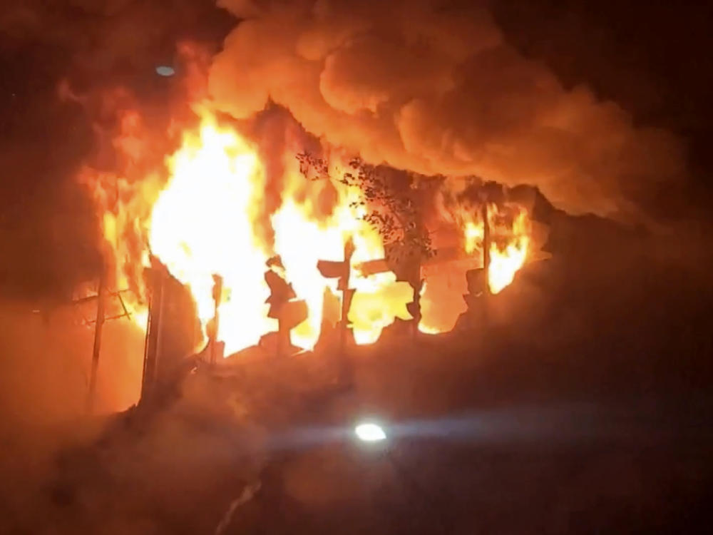 In this image taken from a video, fire and smoke pour out from a building in Kaohsiung, in southern Taiwan on Thursday. The fire engulfed a 13-story building overnight.