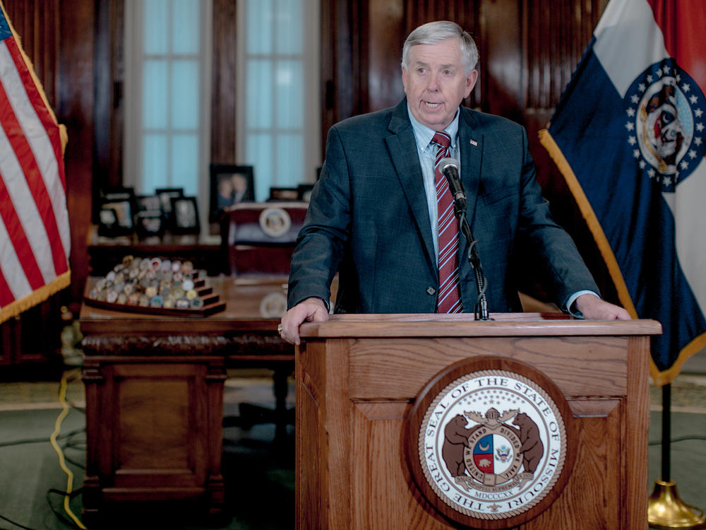 Missouri Gov. Mike Parson, pictured here at a news conference in May 2019, said on Thursday that his administration is pursuing the prosecution of a local newspaper reporter who alerted the government to website security flaws.