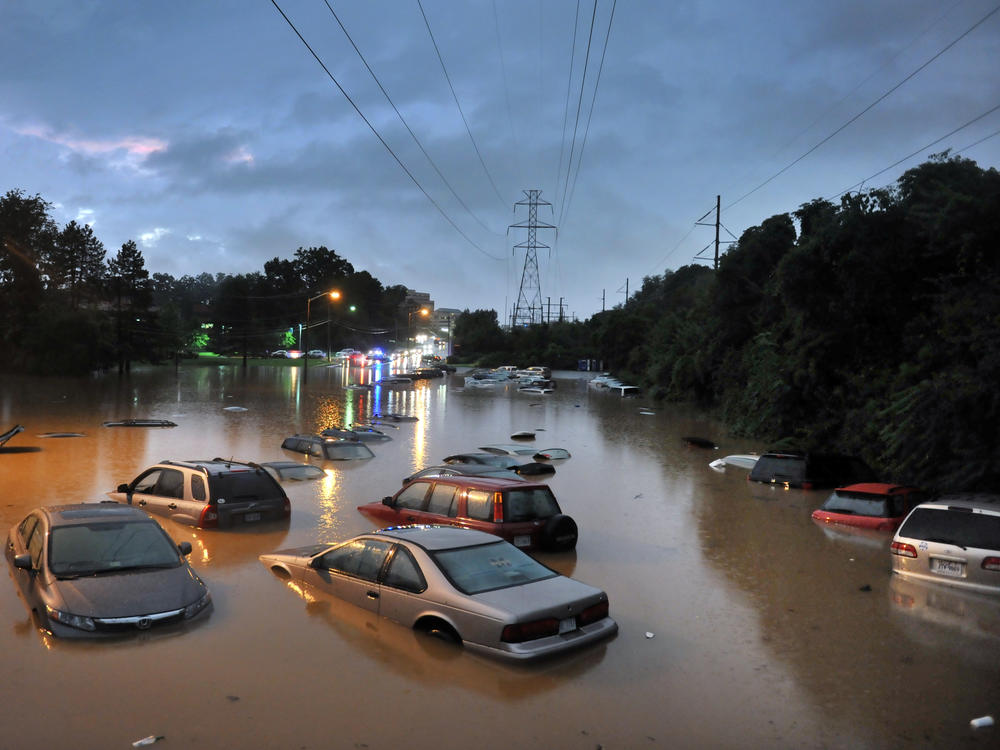 Scenes after heavy rainfall flooded a commuter parking lot in Reston, VA with some cars completely submerged.