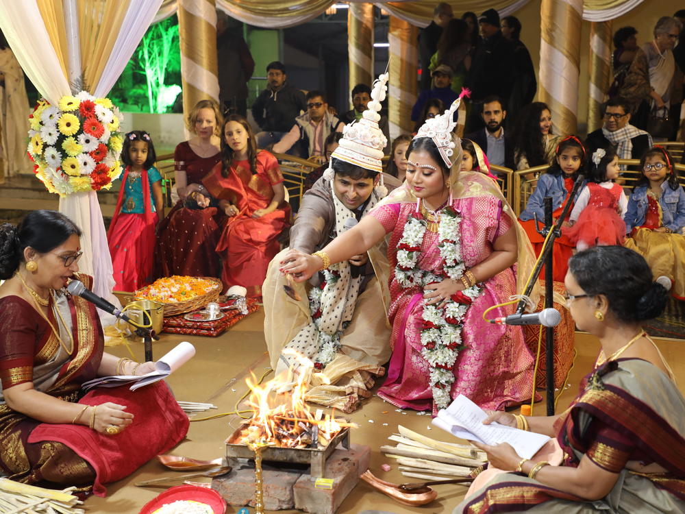 Sharmistha Chaudhuri (center, wearing pink), 35, at her wedding in Kolkata, India, in January 2020. Chaudhuri found some Indian wedding traditions retrograde, so she hired four feminist priestesses to officiate at hers. They performed a multilingual, egalitarian ceremony stripped of patriarchal traditions.