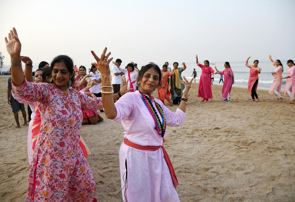 Women dance on Juhu beach in Mumbai during the Durga Puja festival.