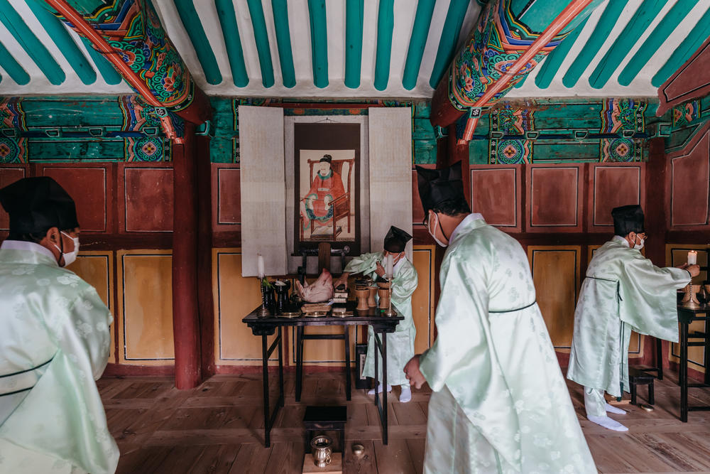 Men check ancestral offerings before the spring ceremony starts at Museong Seowon. A painting of Museong Seowon's venerated scholar, Choe Chi-won, a celebrated poet and scholar of Silla kingdom, looks over the offering table.