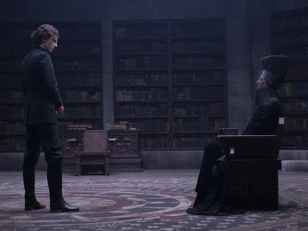 Paul (Timothee Chalamet) and the Bene Gesserit Reverend Mother (Charlotte Rampling) regard each other warily in DUNE.
