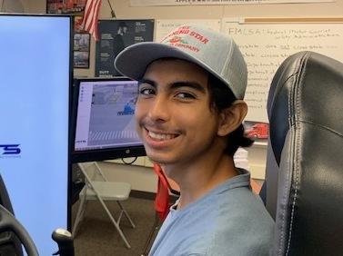 High school senior Eduardo Dominguez-Sotelo sits behind the wheel of a simulator of an 18-wheeler, a part of the Patterson High School truck driving program.