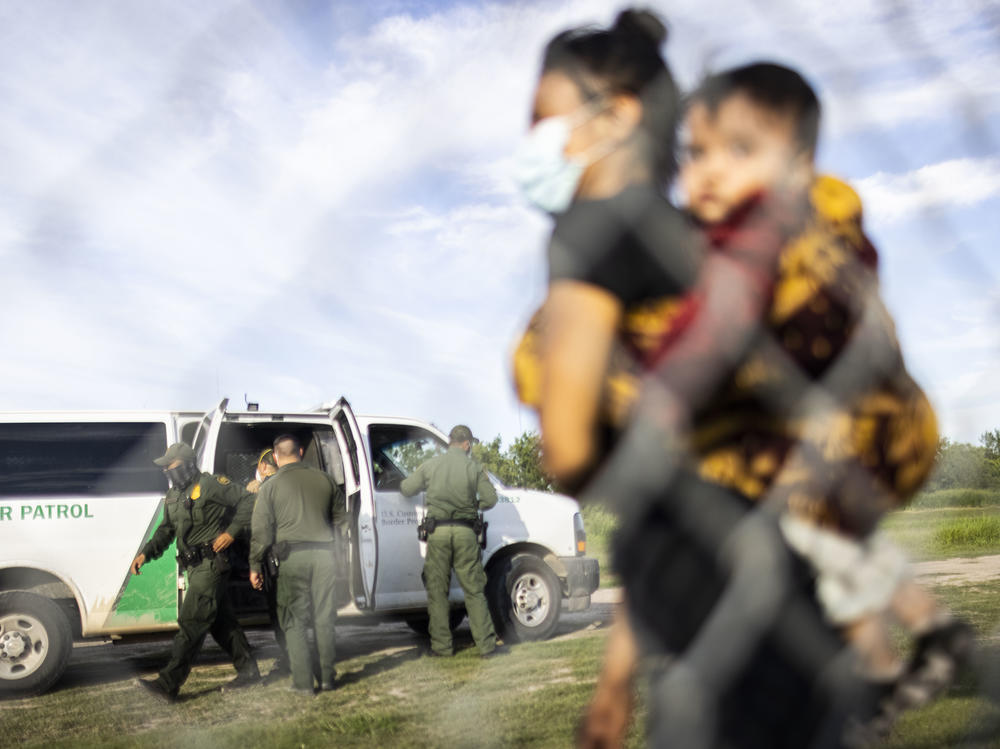 Migrants are apprehended by U.S. Customs and Border Protection (CBP) agents after crossing the Rio Grande in LaJoya, Texas on June 12. Benioff kept Salesforce's contract with the CBP despite opposition from his own employees.
