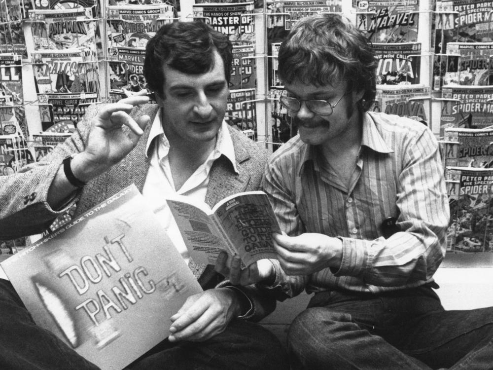British author Douglas Adams, left, and Nick Landau read Adams' book <em>The Hitchhiker's Guide To The Galaxy</em> in October 1979.
