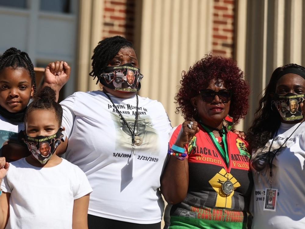 Members of Ahmaud Arbery's family, including aunts Thea Brooks and Carla Arbery, rally outside of the Glynn County Courthouse Saturday, ahead of the trial of the men who face charges in his death.