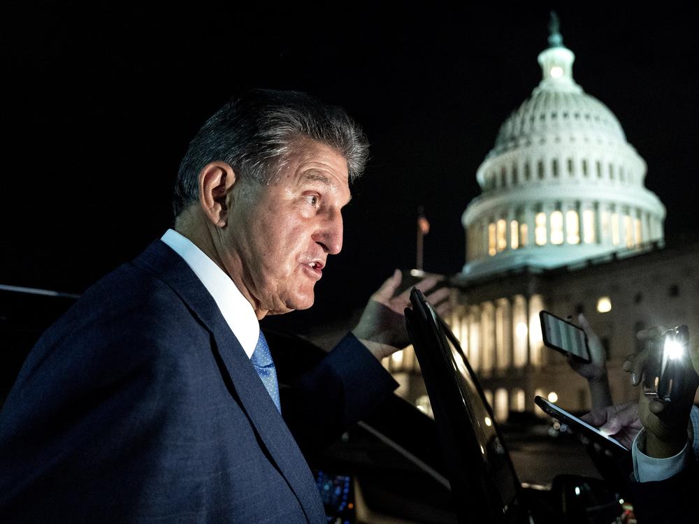 Sen. Joe Manchin, a Democrat from West Virginia, speaks to members of the media while departing the U.S. Capitol on Oct. 7. Manchin has reportedly told the White House that he opposes the key climate measure in Biden's multitrillion-dollar climate and social programs package.
