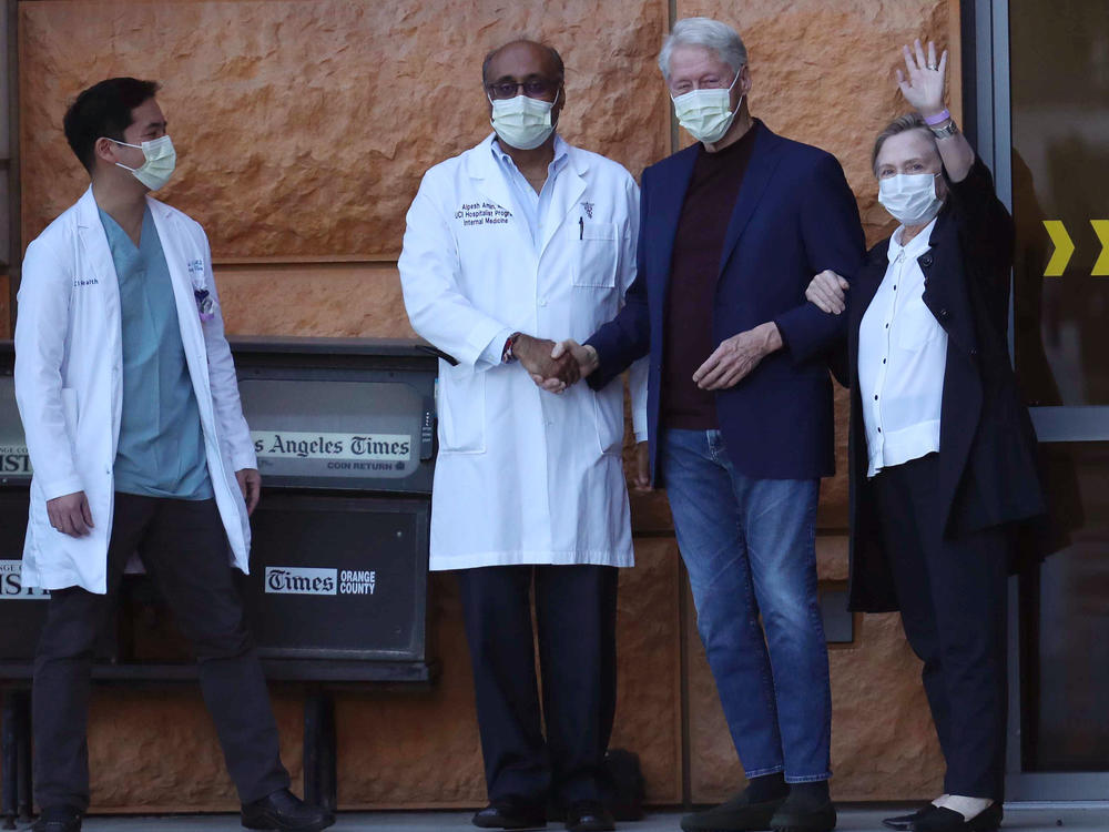 Former President Bill Clinton, standing with his wife, Hillary, and doctors, was discharged from UC Irvine Medical Center Sunday morning.