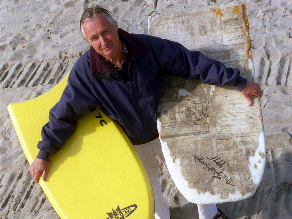 Tom Morey, inventor of the Boogie Board, is photographed on Capistrano Beach holding a newer model (left) and (right) his original 1971 Boogie Board.