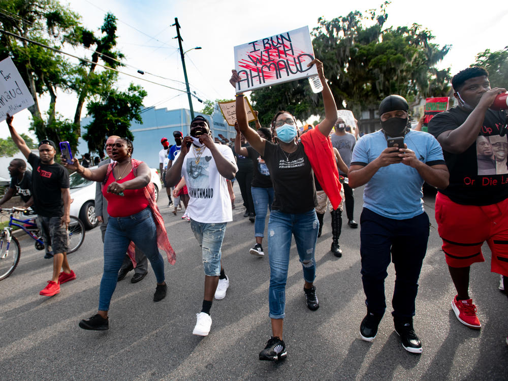 Demonstrators march on June 4, 2020 in Brunswick, Ga., after a court appearance by Gregory and Travis McMichael, two suspects in the fatal shooting of Ahmaud Arbery.