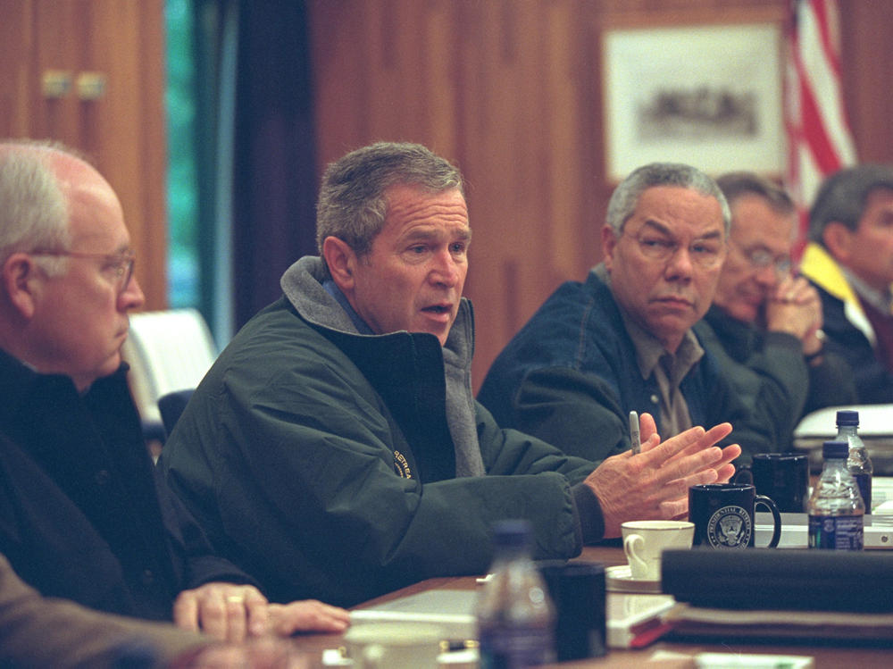 With Powell at his side, President George W. Bush meets with members of the National Security Council at Camp David in September 2001.