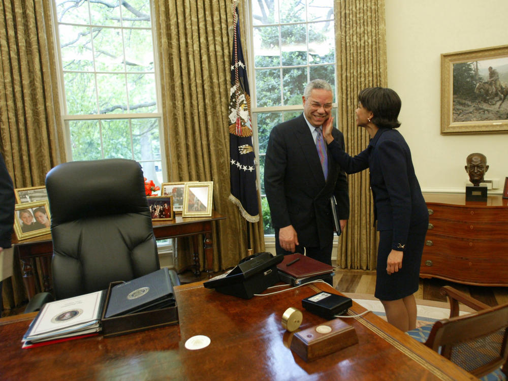 Secretary of State Colin Powell gets a pat on the cheek form national security advisor Condoleezza Rice during a meeting with President George W. Bush and Israeli Prime Minister Ariel Sharon in the Oval Office at the White House on May 7, 2002.