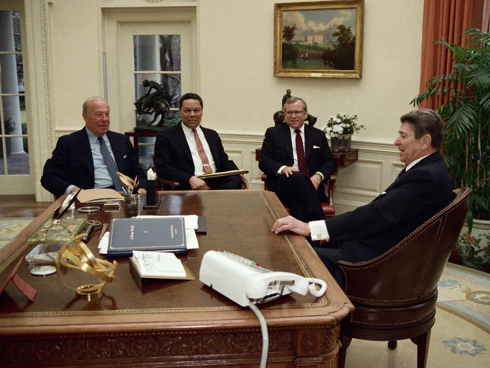President Ronald Reagan meets with Secretary of State George Shultz, along with national security adviser Colin Powell and White House Chief of Staff Howard Baker, in the Oval Office on Feb. 19, 1988, to discuss Shultz's trip for a series of pre-summit meetings with Kremlin leadership.
